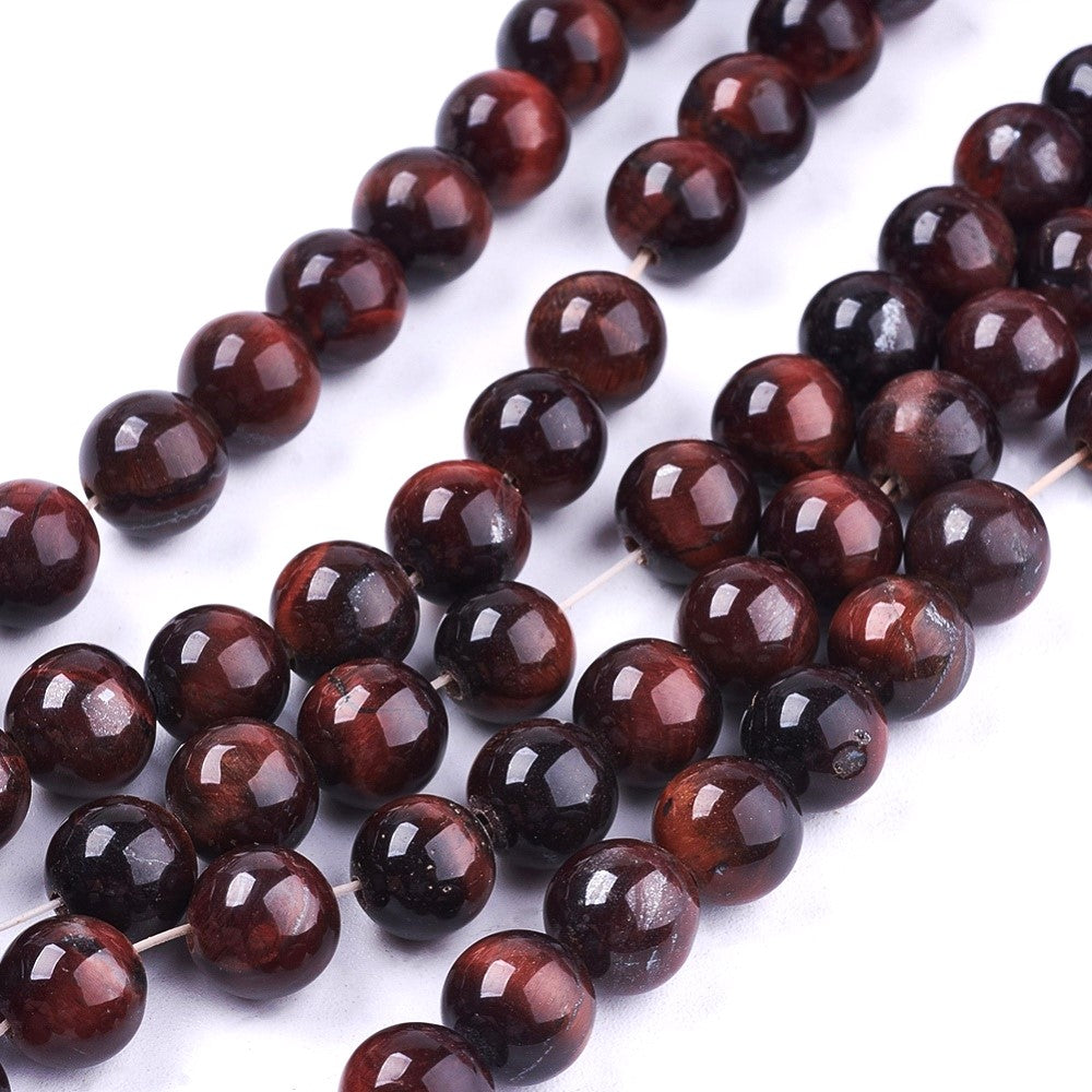 A strand of 57+ tiger eye beads, red and brown in colour, 6mm in size, round shaped