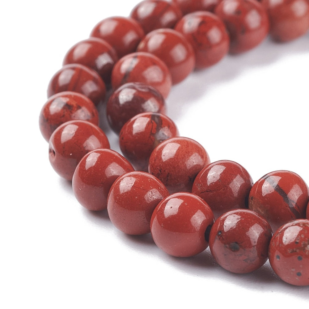 A strand of 60+ jasper beads, red in colour, 6mm in size, round shaped