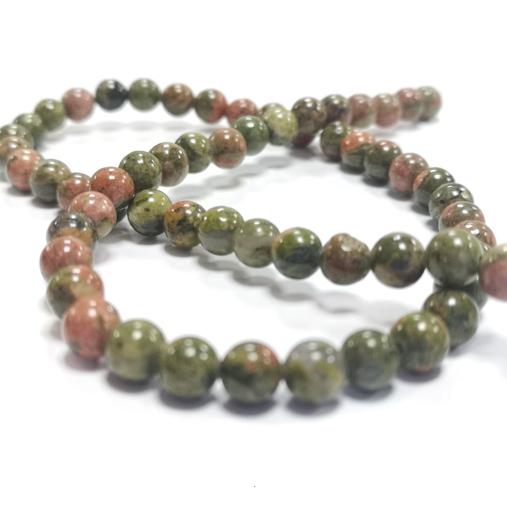 A strand of 56+ unakite beads, green and orange in colour, 6mm in size, round shaped