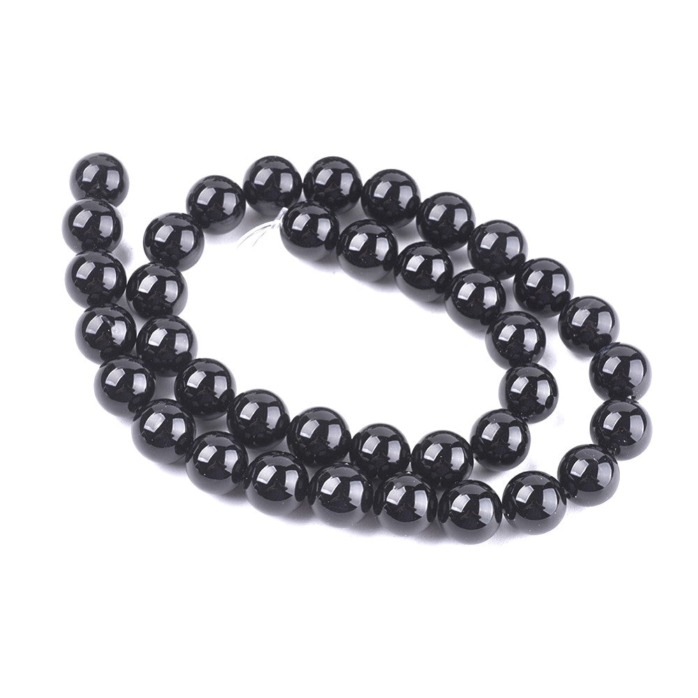 A strand of 38+ onyx beads, black in colour, 10mm in size, round shaped
