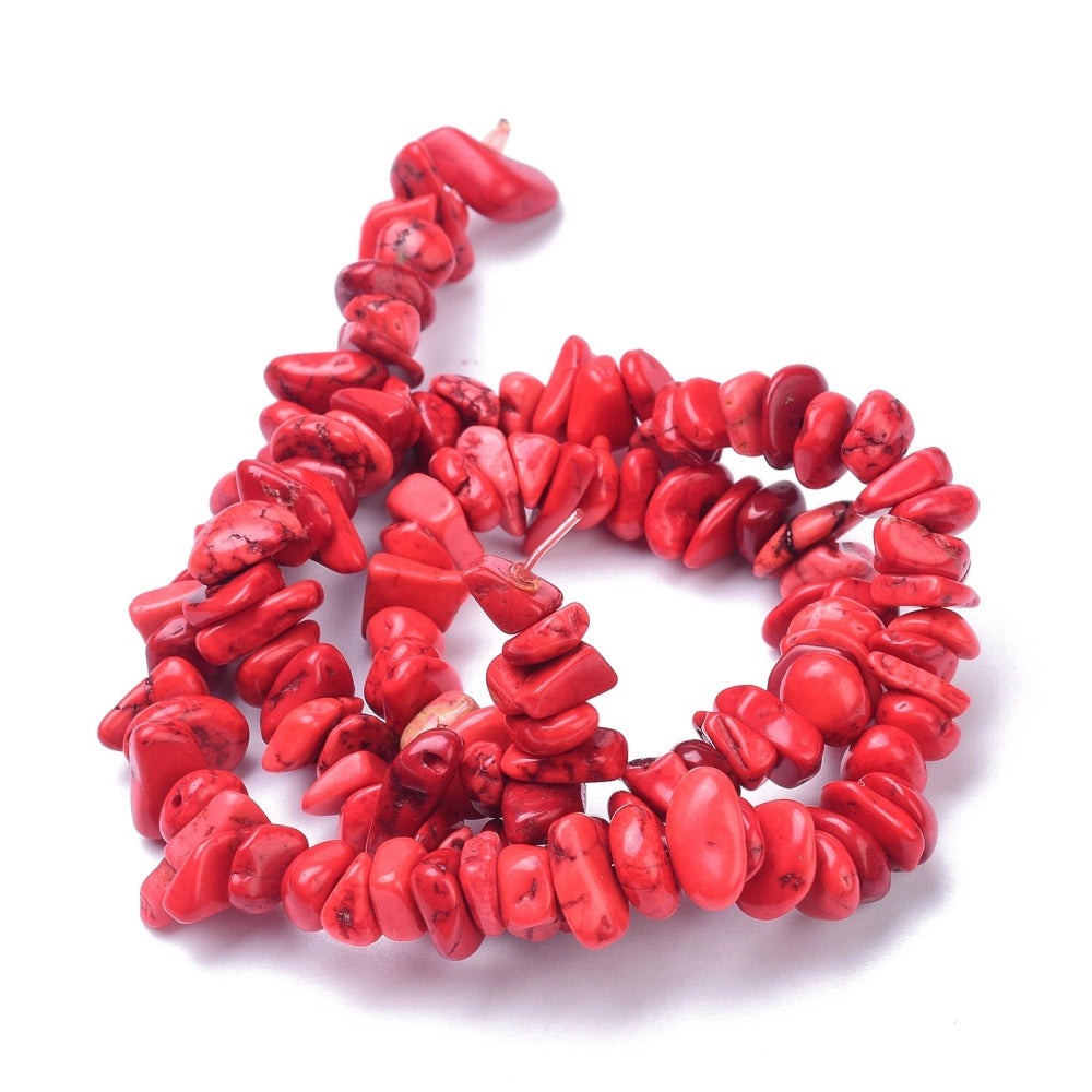 A strand of 70+ magnesite beads, red in colour, 6-12mm in size, chip shaped