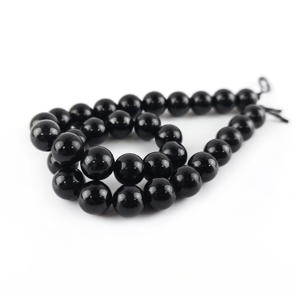 A strand of 29+ Tourmaline beads, black in colour, 6mm in size, round shaped