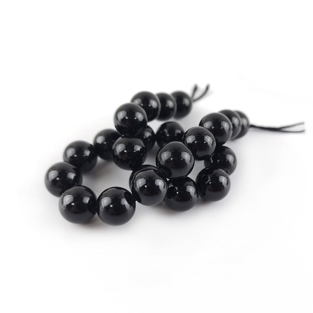 A strand of 20+ Tourmaline beads, black in colour, 8mm in size, round shaped