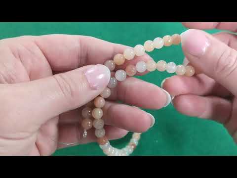 A strand of 57+ aventurine beads, peach in colour, 6mm in size, round shaped