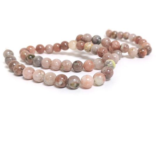 A strand of 60+ lepidolite beads, pink and yellow in colour, 6mm in size, round shaped