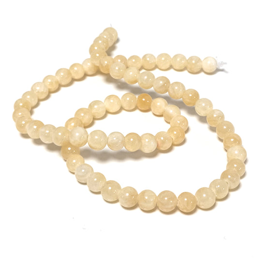 A strand of 55+ honey jade beads, yellow in colour, 6mm in size, round shaped