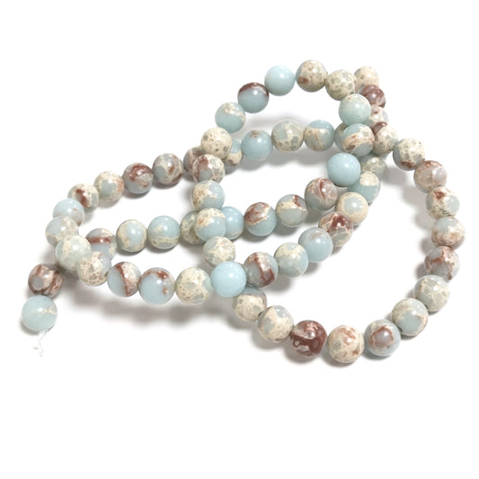 A strand of 62+ Aqua Terra Jasper beads, pale blue and red in colour, 6mm in size, round shaped