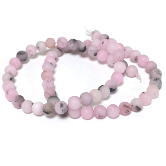 A strand of 60+ Cherry Blossom Jasper beads, pink and black in colour, 6mm in size, round shaped