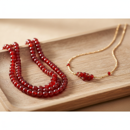 Red carnelian 6mm bead strands with finished bracelet and necklace on wooden jewellery display tray