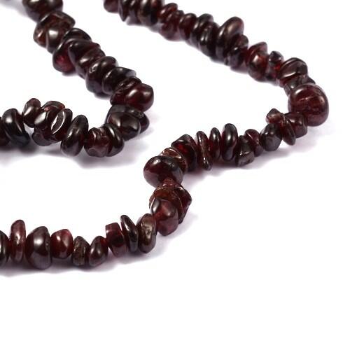 A strand of 200+ garnet beads, dark red in colour, 4-6mm in size, chip shaped